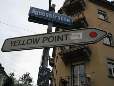 Signpost "YELLOW POINT" with a red dot on it Yellow or red?